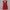 Red mini dress on a hanger against a white curtain background