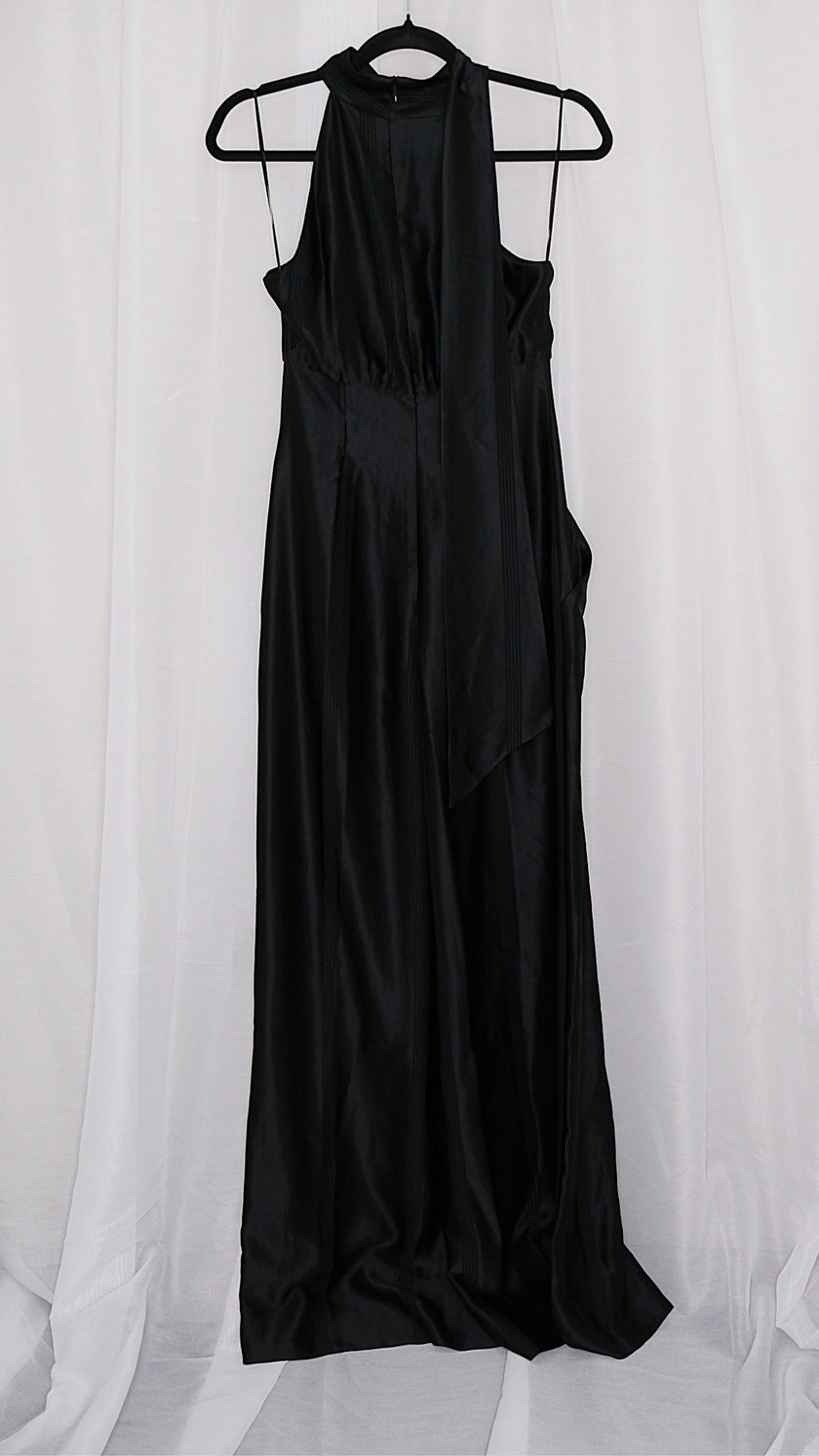 Black satin jumpsuit on a hanger against a white background