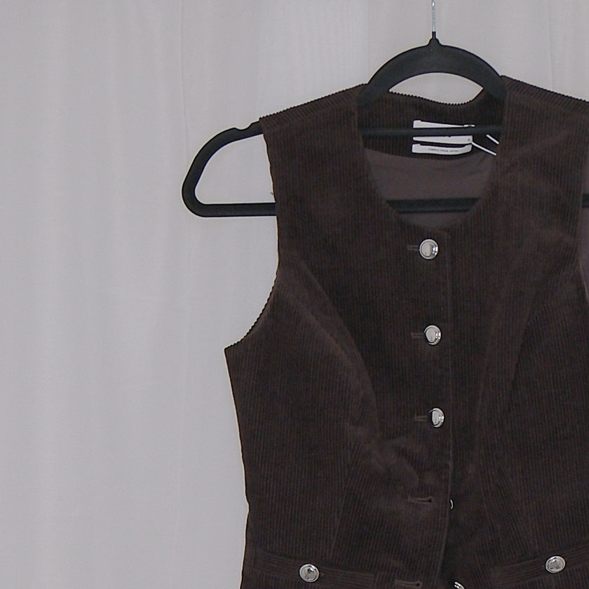 Chocolate corduroy vest and skirt set on hangers against a white background