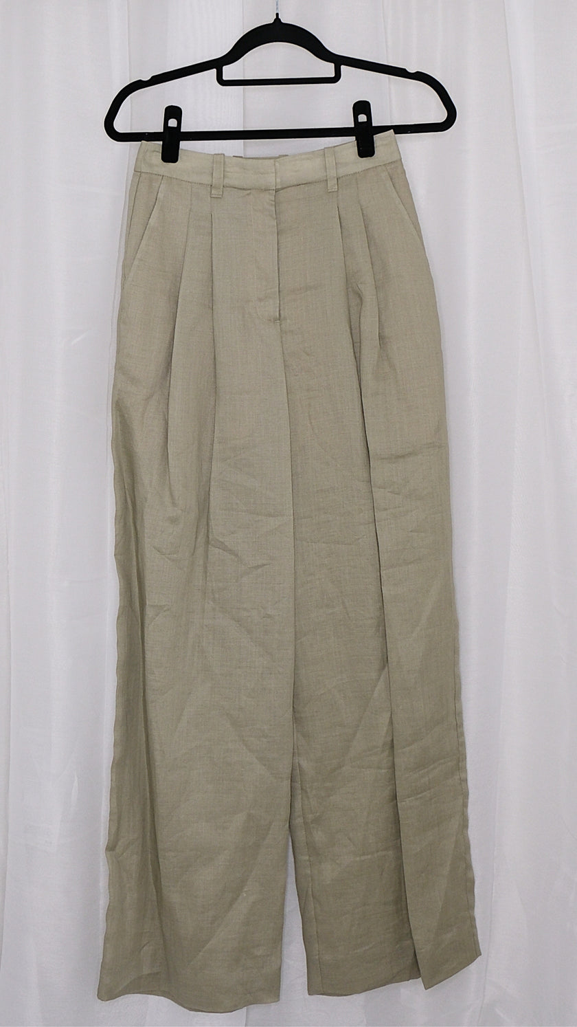 Beige pants on a hanger against a white background