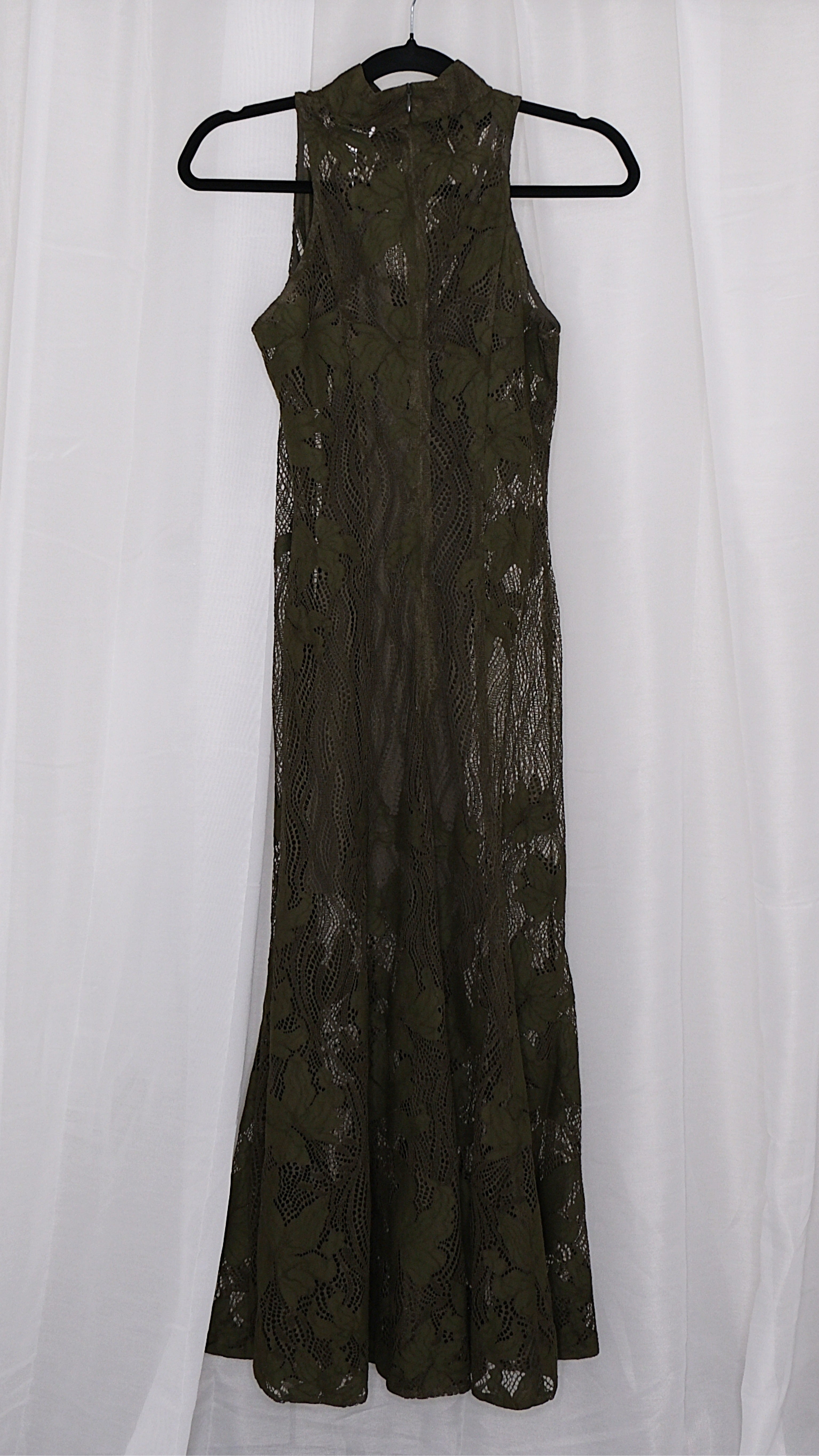 Olive green lace dress on a hanger against a white background