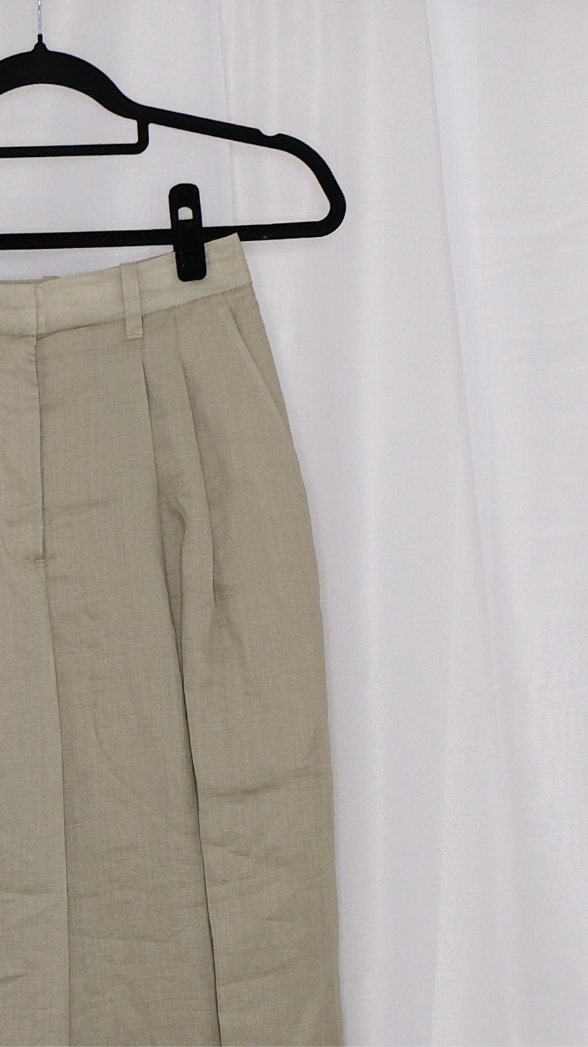 Beige pants on a hanger against a white background