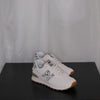 White sneakers with grey leopard design on a black surface and white sheer curtain background