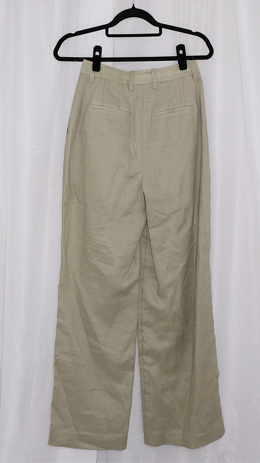 Beige pants on a hanger against a white background