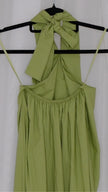 Green halter neck dress on a hanger against a white background
