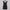 Black mini dress on a hanger against a white curtain background