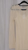 Beige long-sleeve crochet dress on a hanger against a light white background