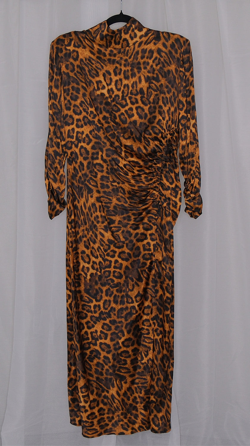 Leopard print dress on a hanger against a plain background