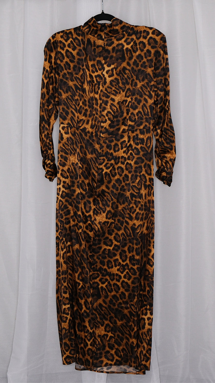 Leopard print dress on a hanger against a plain background