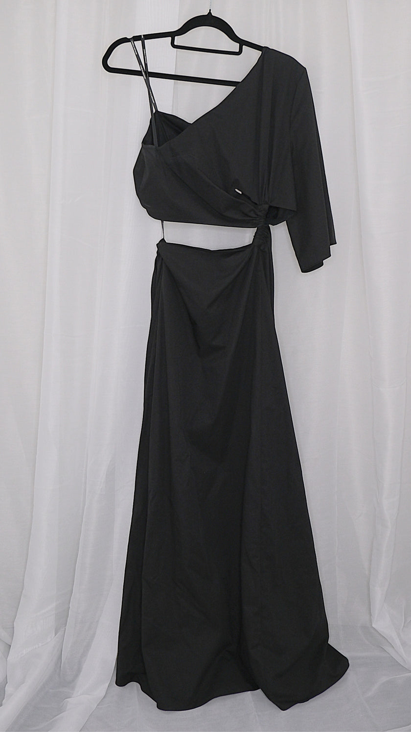 Black asymmetrical dress with cut outs on a hanger against a white background