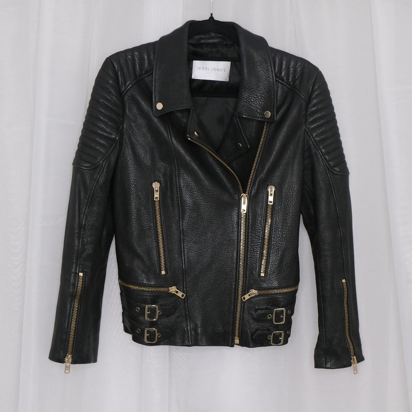 Black leather jacket with gold zippers on a white background