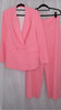 Pink suit with blazer and pants on hangers against a plain background