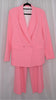 Pink suit with blazer and pants on hangers against a plain background