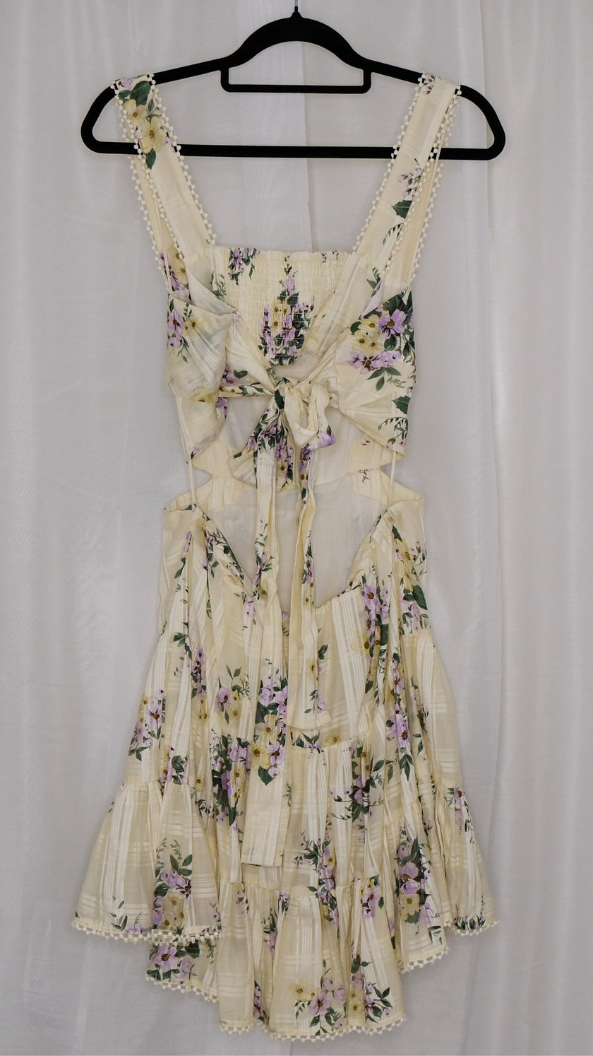 Floral dress on a hanger against a white background
