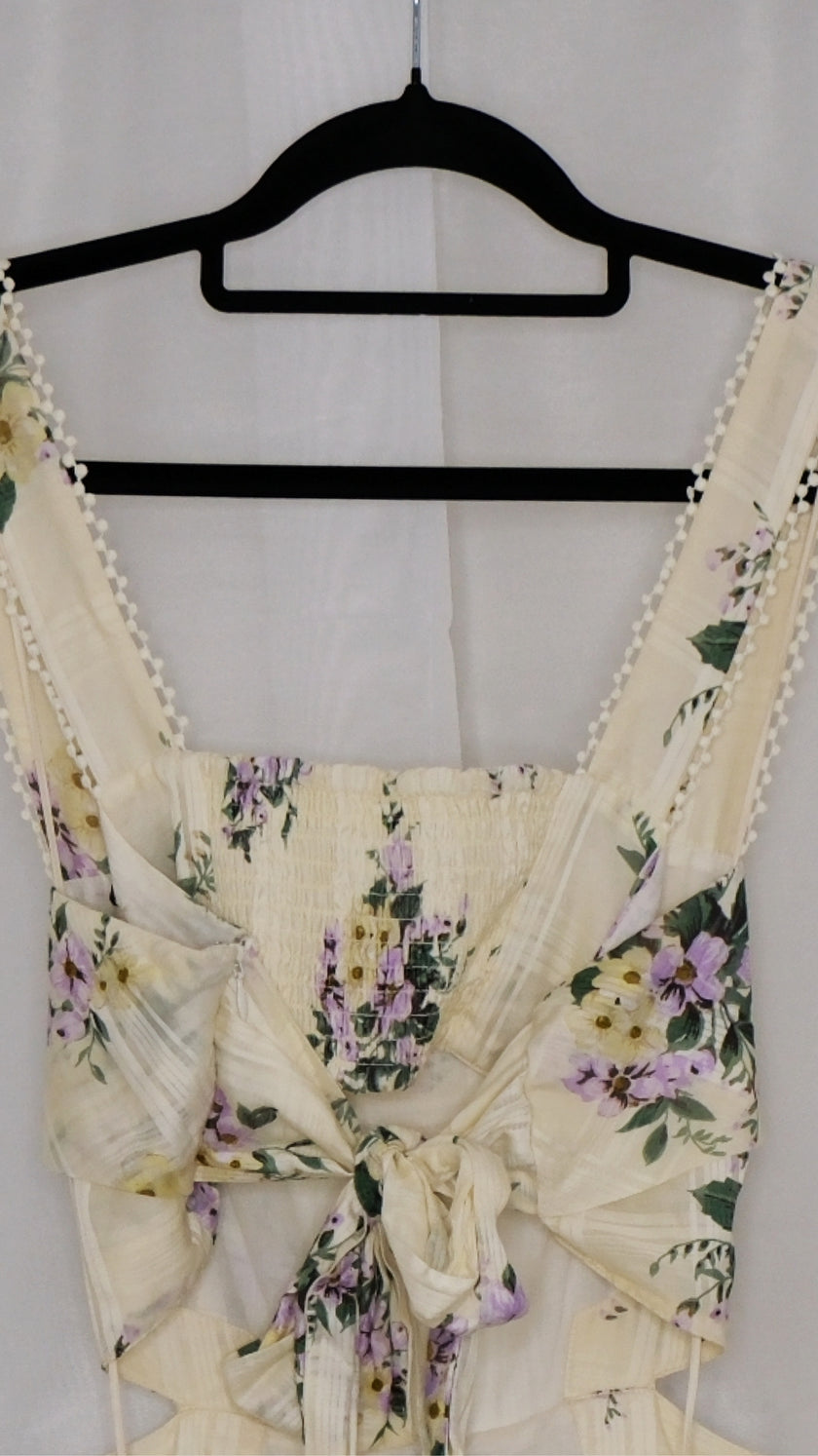 Floral dress on a hanger against a white background