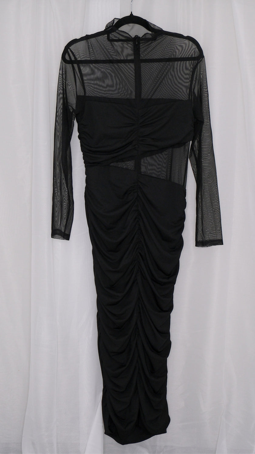 Black mesh dress with sheer sleeves on a hanger against a white background